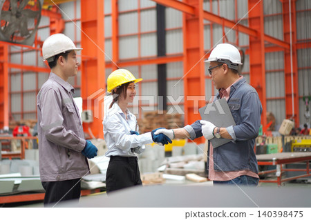 Asian engineers explaining factory machinery operations to a client Asian engineers explaining factory machinery operations to a client 140398475