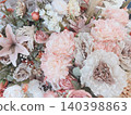 A collection of elegant, muted pink artificial flowers. 140398863