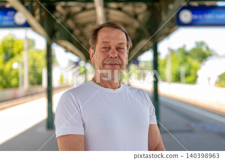 Man Standing on Railway Platform Man Standing on Railway Platform 140398963