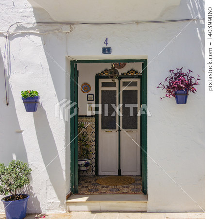 Spain: The white village of Mijas, streetscape with double doors Spain: The white village of Mijas, streetscape with double doors 140399060