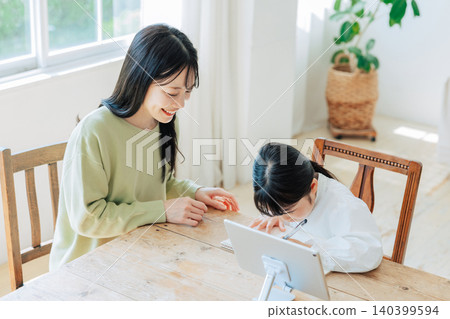 A child studying with their mother A child studying with their mother 140399594