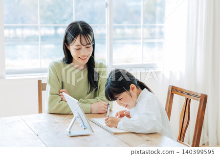 A child studying with their mother A child studying with their mother 140399595