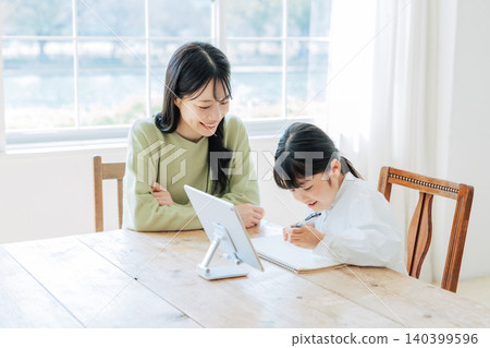 A child studying with their mother A child studying with their mother 140399596