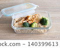 Healthy meal prep containers with with chicken, rice and broccoli on kitchen table 140399613