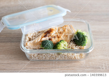 Healthy meal prep containers with with chicken, rice and broccoli on kitchen table 140399613