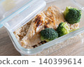 Healthy meal prep containers with with chicken, rice and broccoli on kitchen table 140399614