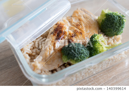 Healthy meal prep containers with with chicken, rice and broccoli on kitchen table 140399614