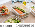 Healthy meal prep containers with salmon, chicken, pasta and fresh vegetables 140399619