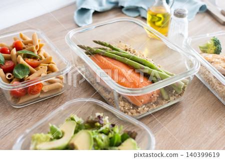 Healthy meal prep containers with salmon, chicken, pasta and fresh vegetables 140399619