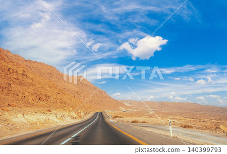 Driving a car in the desert in the early morning Driving a car in the desert in the early morning 140399793