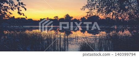 Rural nature landscape. Sunset over the lake. Magic colorful sunset in the countryside. Rural landscape in the evening. Beautiful summer nature 140399794