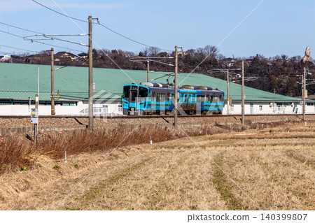 The blue local train of the IR Ishikawa Railway 521 series running through the Hokuriku region (rural scenery around Kaga Onsen and Daishoji) The blue local train of the IR Ishikawa Railway 521 series running through the Hokuriku region (rural scenery around Kaga Onsen and Daishoji) 140399807