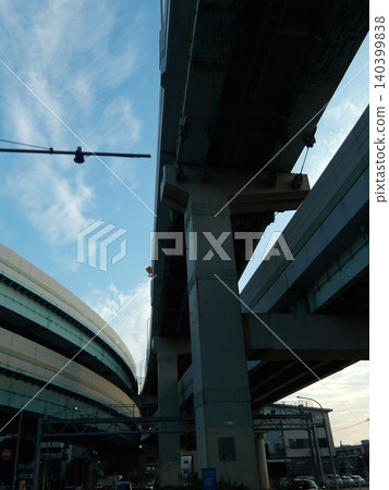 The massive bridge piers of the elevated highway and the complex network of intersecting highway junctions. The massive bridge piers of the elevated highway and the complex network of intersecting highway junctions. 140399838