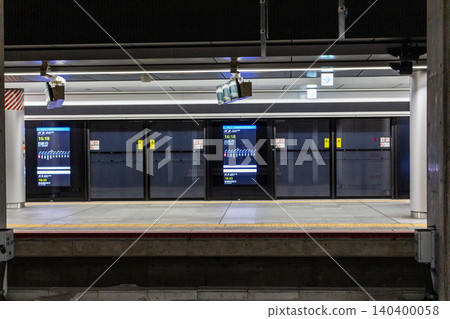 Futuristic full-screen platform doors and digital signage on the underground platform of the station. Futuristic full-screen platform doors and digital signage on the underground platform of the station. 140400058
