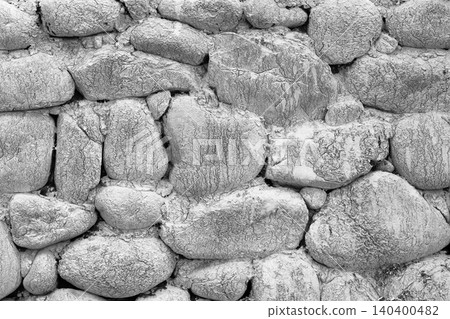 Ancient masonry wall built with natural gray river stones Ancient masonry wall built with natural gray river stones 140400482