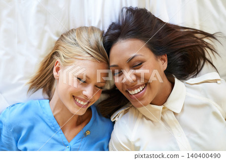 Women, friends and bed relax as top view with holiday accommodation for bonding weekend, connection or vacation. Female people, group and happiness in Miami for hospitality, resting or comfortable Women, friends and bed relax as top view with holiday accommodation for bonding weekend, connection or vacation. Female people, group and happiness in Miami for hospitality, resting or comfortable 140400490