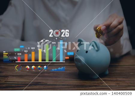 Financial planning, hand putting coin into blue piggy bank with growth chart, saving strategy investment goal and future wealth Financial planning, hand putting coin into blue piggy bank with growth chart, saving strategy investment goal and future wealth 140400509
