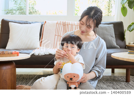 A mother tries to correct her habit of holding her child in the living room and leaving their mouth open. A mother tries to correct her habit of holding her child in the living room and leaving their mouth open. 140400589