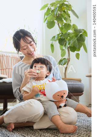 A mother tries to correct her habit of holding her child in the living room and leaving their mouth open. 140400591