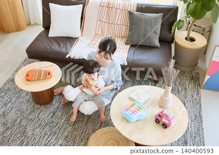 A mother playing with her child in the living room A mother playing with her child in the living room 140400593