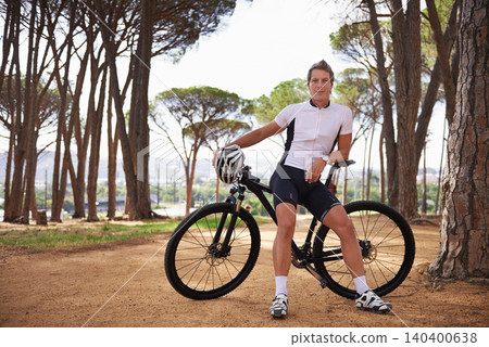 Portrait, bike and break with man in forest for off road fitness, sports or outdoor cardio hobby. Cycling, nature and training with confident young athlete sitting on bicycle to relax in woods Portrait, bike and break with man in forest for off road fitness, sports or outdoor cardio hobby. Cycling, nature and training with confident young athlete sitting on bicycle to relax in woods 140400638