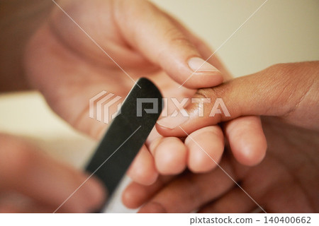 Hands, manicure and file nails in salon for beauty treatment, relax or care. Closeup, spa and tool on fingernail for filing at cosmetic service with professional, grooming and cleaning for wellness 140400662