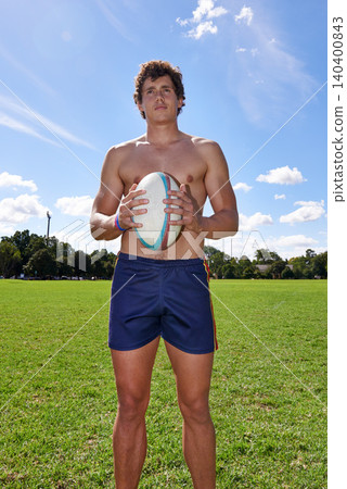 Man, field and rugby ball for fitness with workout, thinking and vision for sport on grass in summer. Person, athlete and outdoor for strategy in game, competition or contest with training in nature Man, field and rugby ball for fitness with workout, thinking and vision for sport on grass in summer. Person, athlete and outdoor for strategy in game, competition or contest with training in nature 140400843