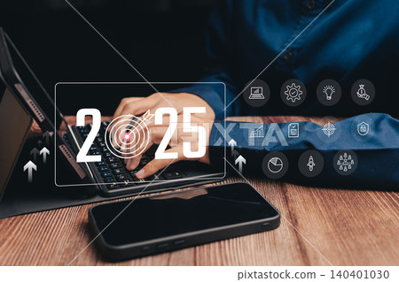 Person Typing on Laptop with Target Year 2025 and Digital Icons for Business Strategy, Business concept Person Typing on Laptop with Target Year 2025 and Digital Icons for Business Strategy, Business concept 140401030