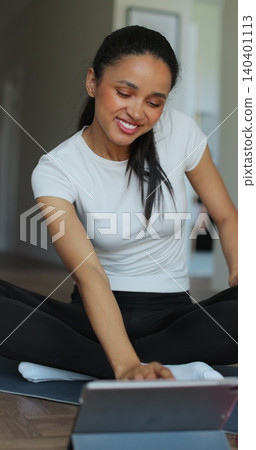 Vertical video. Young sport woman resting, drink water after workout at home. Sports female doing training. Vertical video. Young sport woman resting, drink water after workout at home. Sports female doing training. 140401113