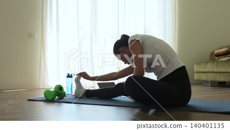 Online video tutorial while virtual training at home. Workout at home in living room, viewing online training on tablet. Online video tutorial while virtual training at home. Workout at home in living room, viewing online training on tablet. 140401135