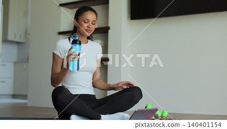 Online video tutorial while virtual training at home. Workout at home in living room, viewing online training on tablet. Online video tutorial while virtual training at home. Workout at home in living room, viewing online training on tablet. 140401154