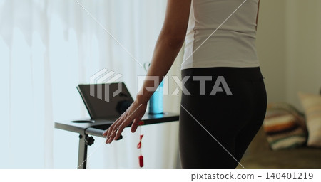 Back view. Fitness, girl and walking on treadmill in home for cardio exercise, wellness challenge and burning calories. Back view. Fitness, girl and walking on treadmill in home for cardio exercise, wellness challenge and burning calories. 140401219