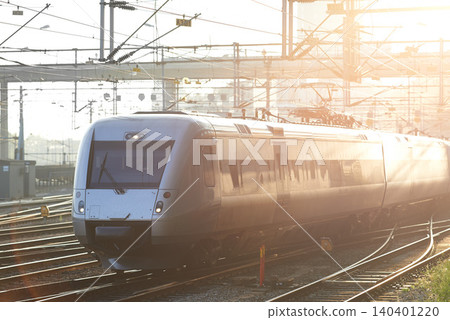 Train, station and tracks outdoor for travel, commute and journey or transportation in morning sunshine. Subway, infrastructure and railway or railroad for public service, tourism and city technology Train, station and tracks outdoor for travel, commute and journey or transportation in morning sunshine. Subway, infrastructure and railway or railroad for public service, tourism and city technology 140401220