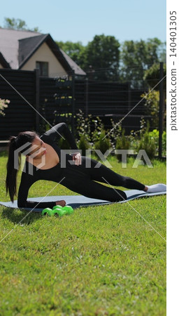 Vertical video. Young woman doing sports at nature, Female fitness training in sportswear. Sport, fitness, health and lifestyle concept. Vertical video. Young woman doing sports at nature, Female fitness training in sportswear. Sport, fitness, health and lifestyle concept. 140401305