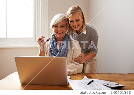 Woman, senior mother and laptop for finance in home, support and help for ecommerce on website. Daughter, old person and paperwork for tax return, investment and teaching on tech for online banking Woman, senior mother and laptop for finance in home, support and help for ecommerce on website. Daughter, old person and paperwork for tax return, investment and teaching on tech for online banking 140401558