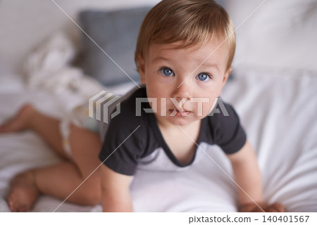 Curious, baby and crawl on bed in portrait, boy and kid for motor skills in bedroom on weekend. Child development, toddler and calm or comfortable, wellness and learn for health and growth in home Curious, baby and crawl on bed in portrait, boy and kid for motor skills in bedroom on weekend. Child development, toddler and calm or comfortable, wellness and learn for health and growth in home 140401567