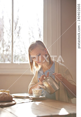 Woman, pouring and tea in home for morning, calm routine and drink on table. Girl, relax and coffee break with food, snacks or teapot in hands for breakfast preparation on holiday or vacation Woman, pouring and tea in home for morning, calm routine and drink on table. Girl, relax and coffee break with food, snacks or teapot in hands for breakfast preparation on holiday or vacation 140401608