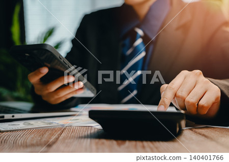 Business Professional Using Smartphone and Calculator in Modern Office Environment, Business concept 140401766