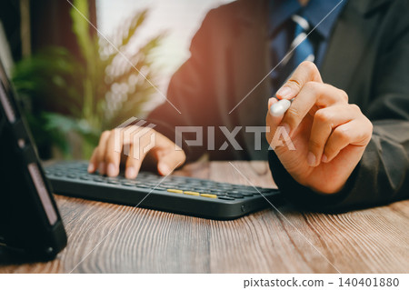 Business Professional Working on Computer with Stylish Pen in Modern Office Environment, Business concept Business Professional Working on Computer with Stylish Pen in Modern Office Environment, Business concept 140401880