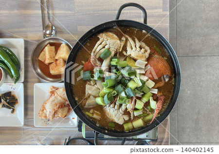 Spicy Blue Crab Stew with kimchi and kkakdugi side dishes Korean called Kkotge-tang 140402145