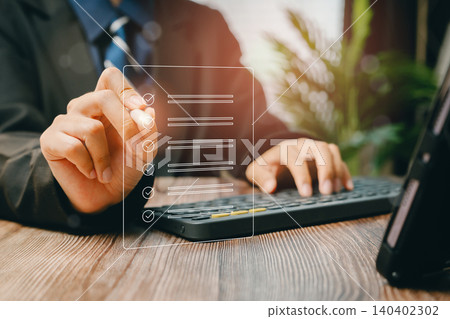 Businessman creating digital checklist on laptop, Business concept 140402302