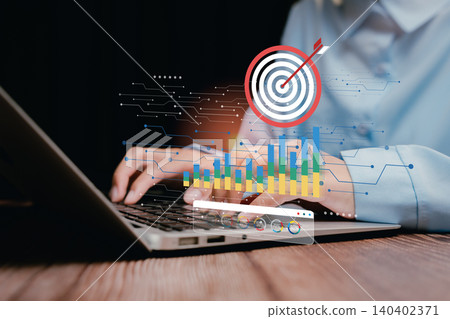 Analytics and Target concept. Focused Business Professional Using Laptop with Analytics and Target Graphics in Modern Workspace Setting Analytics and Target concept. Focused Business Professional Using Laptop with Analytics and Target Graphics in Modern Workspace Setting 140402371
