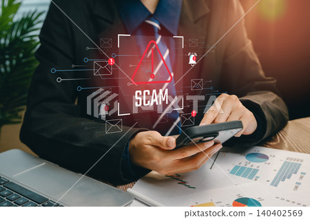 Scam concept. Businessman Alerts on Smartphone About Scams and Cybersecurity Issues in Modern Office Environment Scam concept. Businessman Alerts on Smartphone About Scams and Cybersecurity Issues in Modern Office Environment 140402569