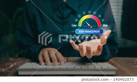 Risk management concept, hand holding digital gauge showing low to high indicator, operational risk assessment, strategic decision support, compliance evaluation, business stability improvement. 140402873