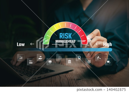 Risk evaluation concept, hand adjusting digital risk level bar from low to high, organizational control system, compliance monitoring, decision support analysis, stability planning improvement. 140402875