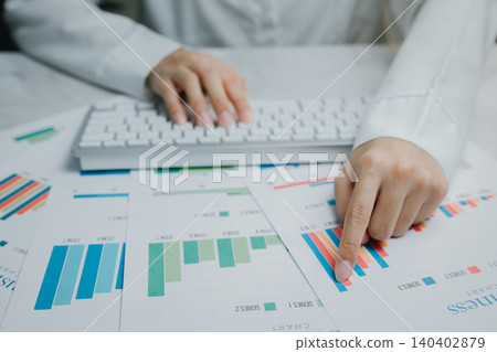 Hands analyzing data charts on a desk surface, Business concept Hands analyzing data charts on a desk surface, Business concept 140402879