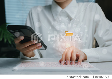 Person Using Smartphone and Computer to Manage Digital Files, business concept 140402974