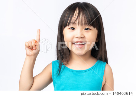 Happy Asian girl pointing finger up having a great idea, eureka moment or discovery concept. Happy Asian girl pointing finger up having a great idea, eureka moment or discovery concept. 140403614