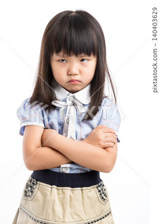 Upset and grumpy Asian girl with arms crossed, looking at camera with angry eyes. Upset and grumpy Asian girl with arms crossed, looking at camera with angry eyes. 140403629