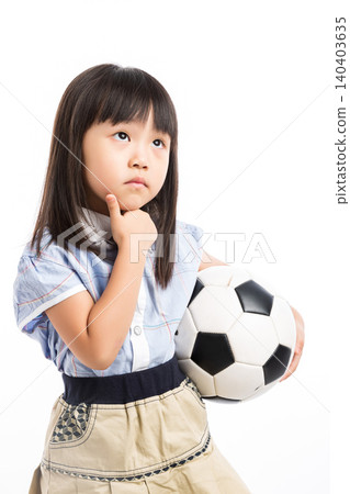 Serious little Asian girl in school uniform holding a soccer ball, thinking or waiting, isolated on white. Serious little Asian girl in school uniform holding a soccer ball, thinking or waiting, isolated on white. 140403635
